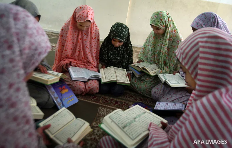 Palestinian girls read the Koran at a summer camp organised by the Islamist movement Hamas in Gaza City, 19 June 2011. About 20,000 students, both male and female, study under the instruction of 1,200 teachers. Hamas usu...