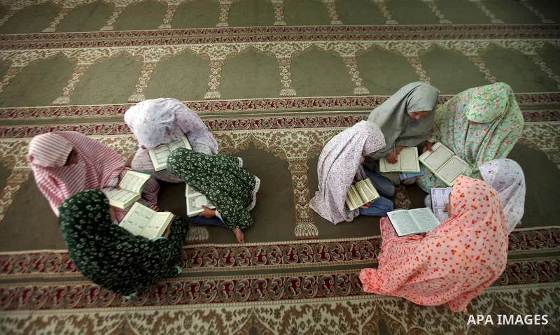 Palestinian girls read the Koran at a summer camp organised by the Islamist movement Hamas in Gaza City, 19 June 2011. About 20,000 students, both male and female, study under the instruction of 1,200 teachers. Hamas usu...