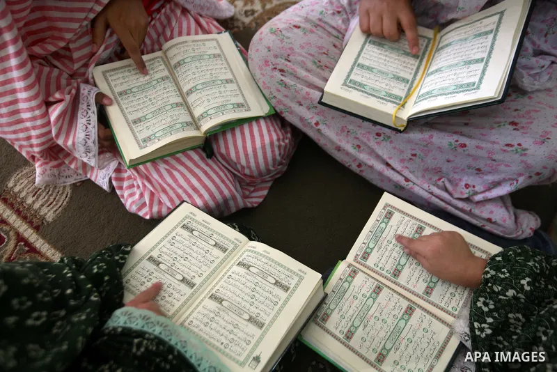 Palestinian girls read the Koran at a summer camp organised by the Islamist movement Hamas in Gaza City, 19 June 2011. About 20,000 students, both male and female, study under the instruction of 1,200 teachers. Hamas usu...