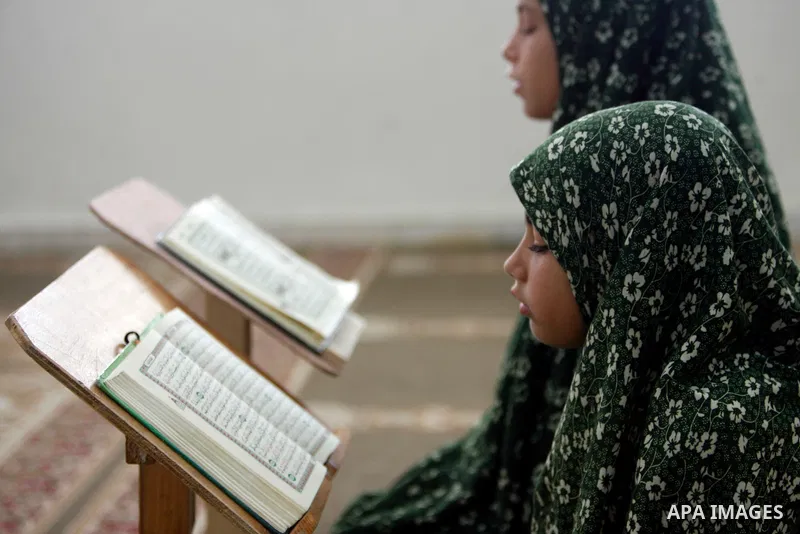 Palestinian girls read the Koran at a summer camp organised by the Islamist movement Hamas in Gaza City, 19 June 2011. About 20,000 students, both male and female, study under the instruction of 1,200 teachers. Hamas usu...