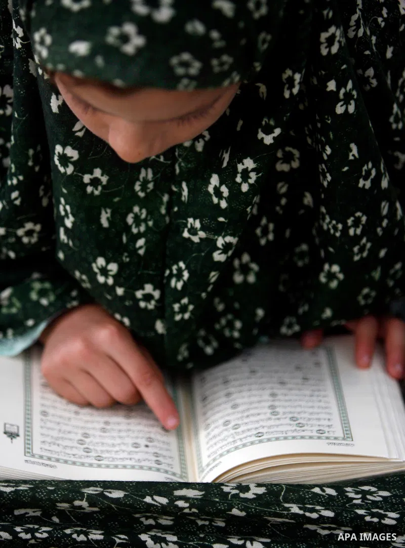 Palestinian girls read the Koran at a summer camp organised by the Islamist movement Hamas in Gaza City, 19 June 2011. About 20,000 students, both male and female, study under the instruction of 1,200 teachers. Hamas usu...