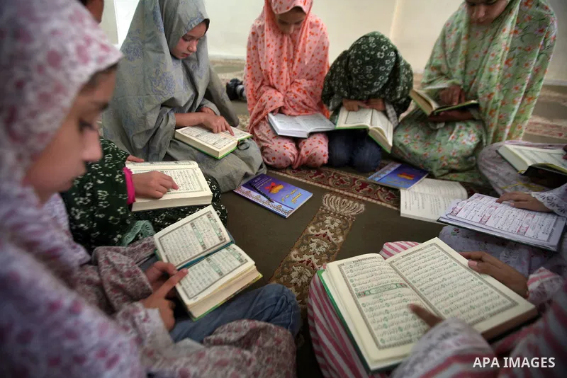 Palestinian girls read the Koran at a summer camp organised by the Islamist movement Hamas in Gaza City, 19 June 2011. About 20,000 students, both male and female, study under the instruction of 1,200 teachers. Hamas usu...