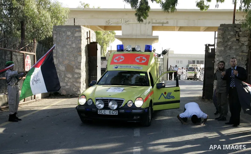 A convoy of "Miles of Smiles 3" carrying medical aid to Gaza crosses the Rafah crossing into the southern Gaza Strip from Egypt on June 19, 2011. The convoy, carrying medical aid for the impoverished Palestinian territor...