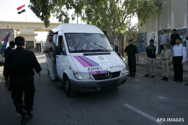 A convoy of "Miles of Smiles 3" carrying medical aid to Gaza crosses the Rafah crossing into the southern Gaza Strip from Egypt on June 19, 2011. The convoy, carrying medical aid for the impoverished Palestinian territor...