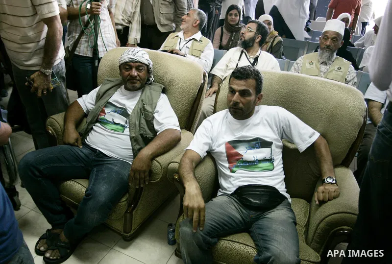 Activists from the "Miles of Smiles 3" charity are welcomed by locals after crossing with medical aid into Gaza through the Rafah crossing Egypt on June 19, 2011. The convoy, carrying medical aid for the impoverished Pal...