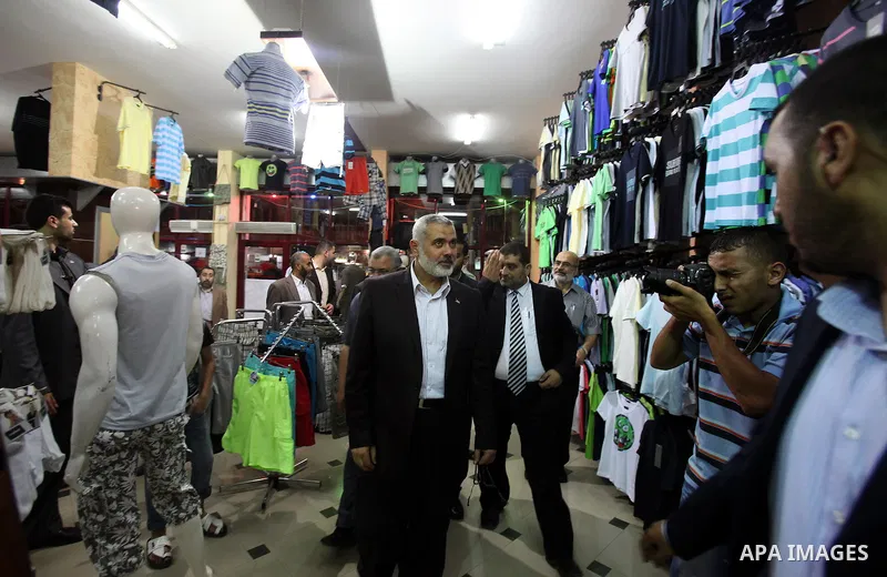 Palestinian Prime Minister in Gaza, Ismail Haniya inspect clothing stores during the opening ceremony of Al-Shuhada Street in Gaza City on June 19, 2011. Photo by Ali Jadallah