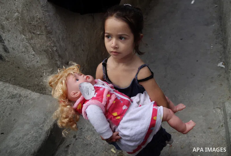 A Palestinian girl plays in front of their house in the Jabaliya refugee camp in the northern area of the Gaza Strip on June 20, 2011. Reports state that the Islamic militant group Hamas is weighing a new strategy of not...