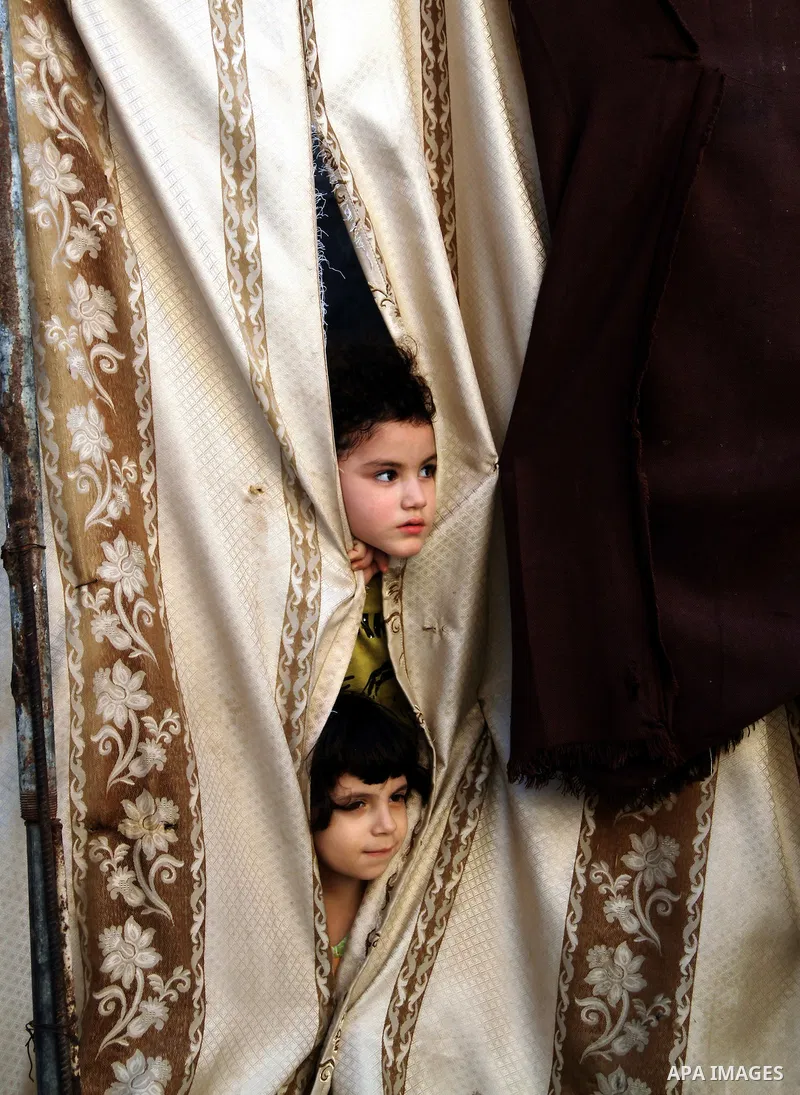 Palestinian children play in front of their house in the Jabaliya refugee camp in the northern area of the Gaza Strip on June 20, 2011. Reports state that the Islamic militant group Hamas is weighing a new strategy of no...