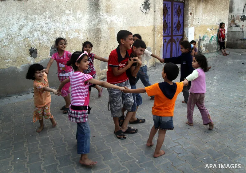Palestinian children play in front of their house in the Jabaliya refugee camp in the northern area of the Gaza Strip on June 20, 2011. Reports state that the Islamic militant group Hamas is weighing a new strategy of no...