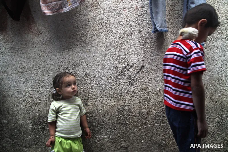Palestinian children play in front of their house in the Jabaliya refugee camp in the northern area of the Gaza Strip on June 20, 2011. Reports state that the Islamic militant group Hamas is weighing a new strategy of no...