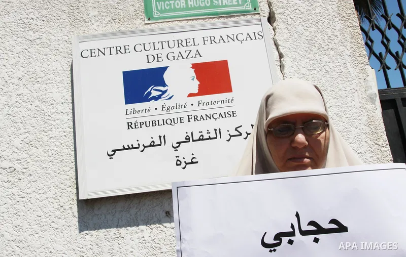 A Palestinian woman supporter of the Islamist movement Hamas demonstrate against the introduction of a ban on the wearing of veils in France, on June 20, 2011 in front of the French Cultural Center in Gaza City. Photo by...
