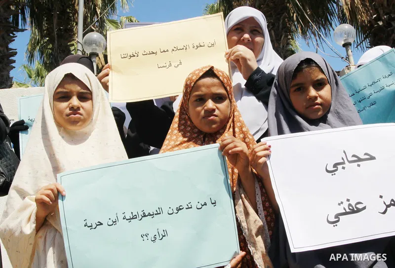 Palestinian women supporters of the Islamist movement Hamas demonstrate against the introduction of a ban on the wearing of veils in France, on June 20, 2011 in front of the French Cultural Center in Gaza City. Photo by...