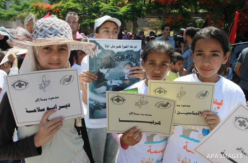 Palestinian children attending a summer camp hold up signs during a protest to mark "nakba" or "catastrophe" of Israel's 1948 creation, on June 20, 2011 in Gaza City. Photo by Naaman Omar