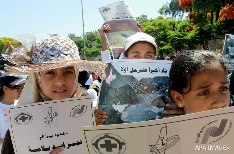 Palestinian children attending a summer camp hold up signs during a protest to mark "nakba" or "catastrophe" of Israel's 1948 creation, on June 20, 2011 in Gaza City. Photo by Naaman Omar