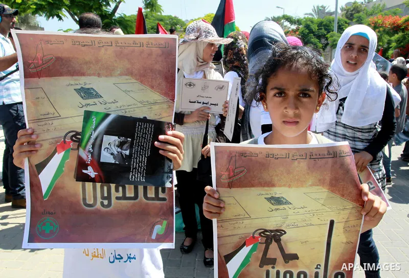 Palestinian children attending a summer camp hold up signs during a protest to mark "nakba" or "catastrophe" of Israel's 1948 creation, on June 20, 2011 in Gaza City. Photo by Naaman Omar