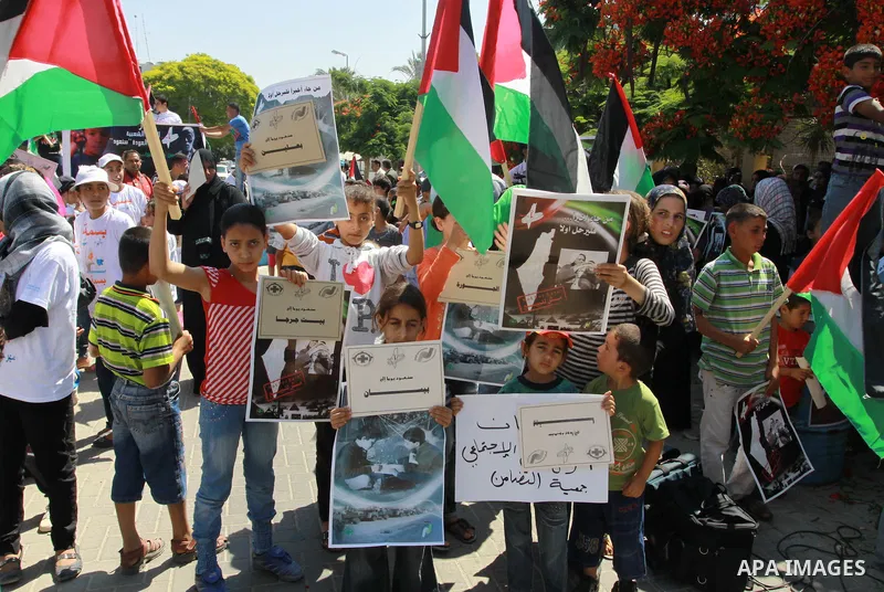 Palestinian children attending a summer camp hold up signs during a protest to mark "nakba" or "catastrophe" of Israel's 1948 creation, on June 20, 2011 in Gaza City. Photo by Naaman Omar