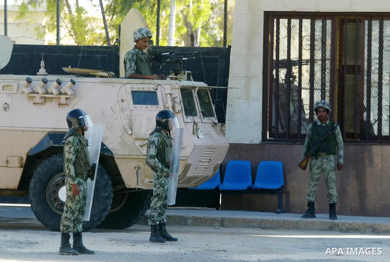 Egyptian soldiers stand guard while the Palestinians wait to cross into Egypt through the Rafah border crossing in the southern Gaza Strip on June 20, 2011. Photo by Abed Rahim Khatib