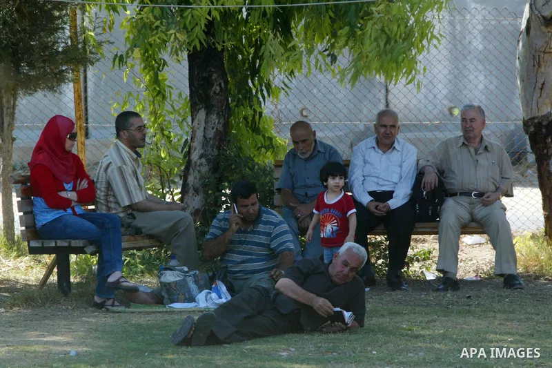 Palestinians wait to cross into Egypt through the Rafah border crossing in the southern Gaza Strip on June 20, 2011. Photo by Abed Rahim Khatib