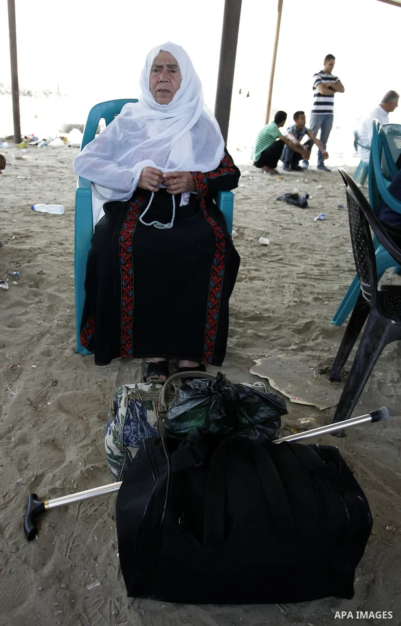 A Palestinian woman waits to cross into Egypt through the Rafah border crossing in the southern Gaza Strip on June 20, 2011. Photo by Abed Rahim Khatib