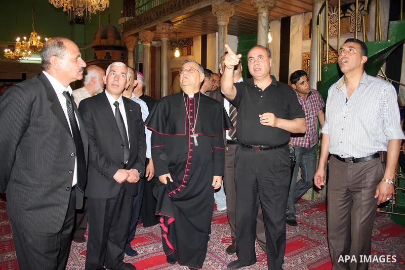 The head of the Roman Catholic Church in the Holy Land, the Latin Patriarch of Jerusalem Fuad Twal walks among Palestinian officials near the Ibrahimi Mosque, or Tomb of the Patriarchs, during a visit to the divided West...