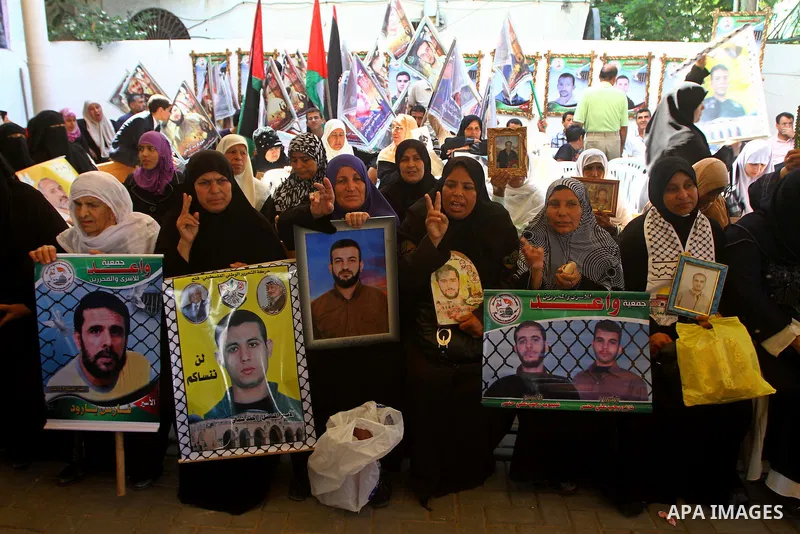 Palestinians hold pictures of their jailed relatives during a protest outside the Red Cross' offices in Gaza City calling for the release of Palestinian prisoners held in Israeli jails, on June 20, 2011. Photo by Ashraf...