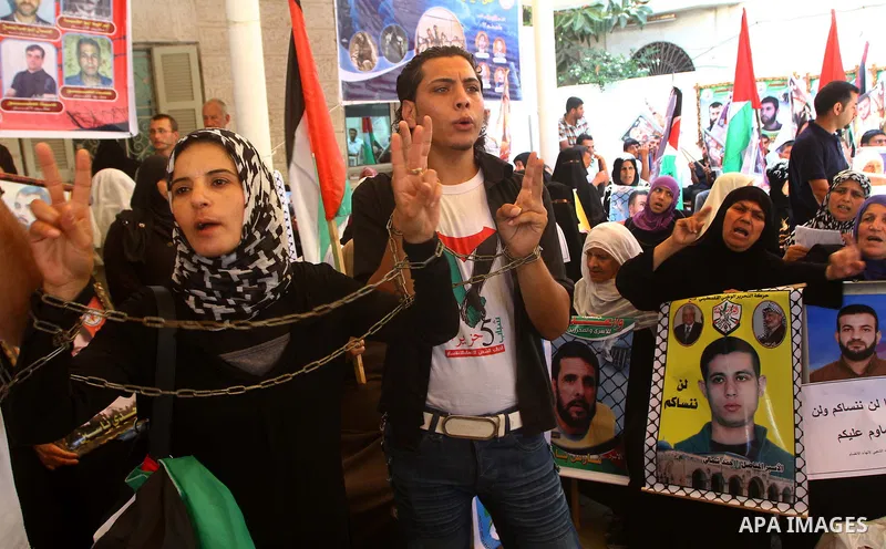 Palestinians hold pictures of their jailed relatives during a protest outside the Red Cross' offices in Gaza City calling for the release of Palestinian prisoners held in Israeli jails, on June 20, 2011. Photo by Ashraf...