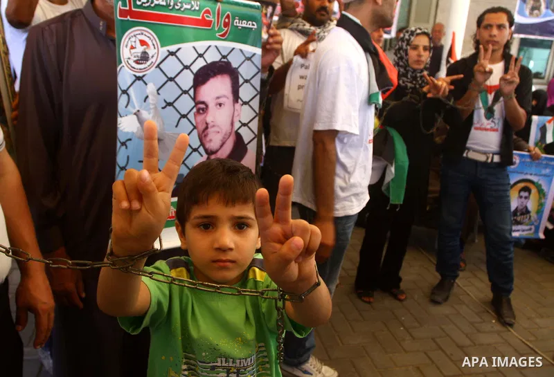 Palestinians hold pictures of their jailed relatives during a protest outside the Red Cross' offices in Gaza City calling for the release of Palestinian prisoners held in Israeli jails, on June 20, 2011. Photo by Ashraf...