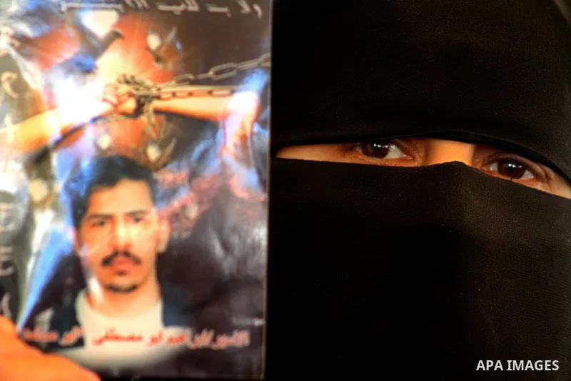 Palestinians hold pictures of their jailed relatives during a protest outside the Red Cross' offices in Gaza City calling for the release of Palestinian prisoners held in Israeli jails, on June 20, 2011. Photo by Ashraf...