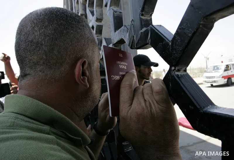 Palestinians wait to cross the Rafah border crossing with Egypt, in the southern Gaza Strip, on June 21, 2011. Demonstrators gathered at the crossing demanding it to be open permanently and without restrictions or condit...