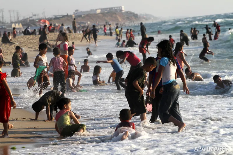Palestinians enjoy swimming in the sea on Gaza's beach on June 21, 2011 in Gaza City. Photo by Mohammed Asad