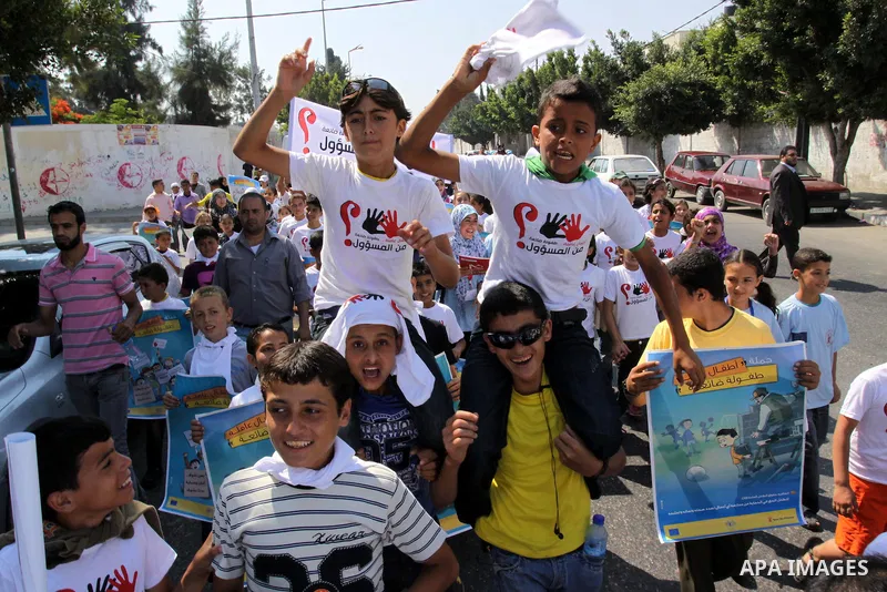 Palestinian children hold up signs during a protest against child labor in Gaza city on June 22, 2011. this protest under the auspices of Save the Children and heading to the Ministry of Labour. Photo by Mohammed Asad