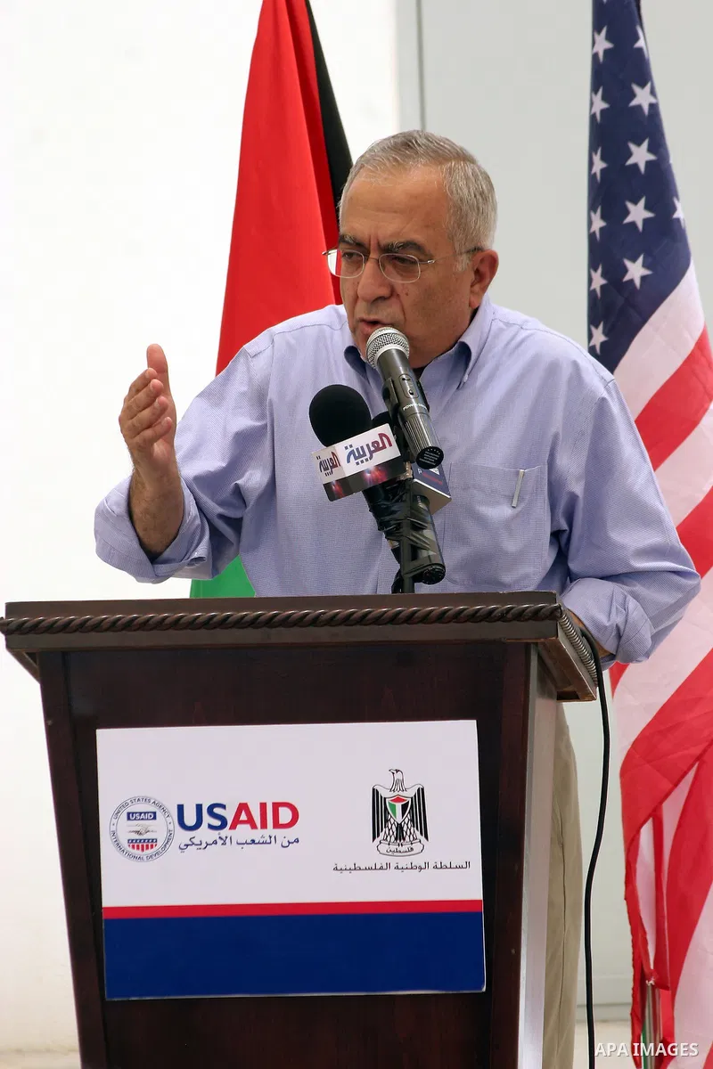 Palestinian prime minister Salam Fayyad delivers a speech during the inauguration ceremony for well stations rehabilitation project in the southern West Bank village of Tuqu'a, which was financed by the US Agency for int...