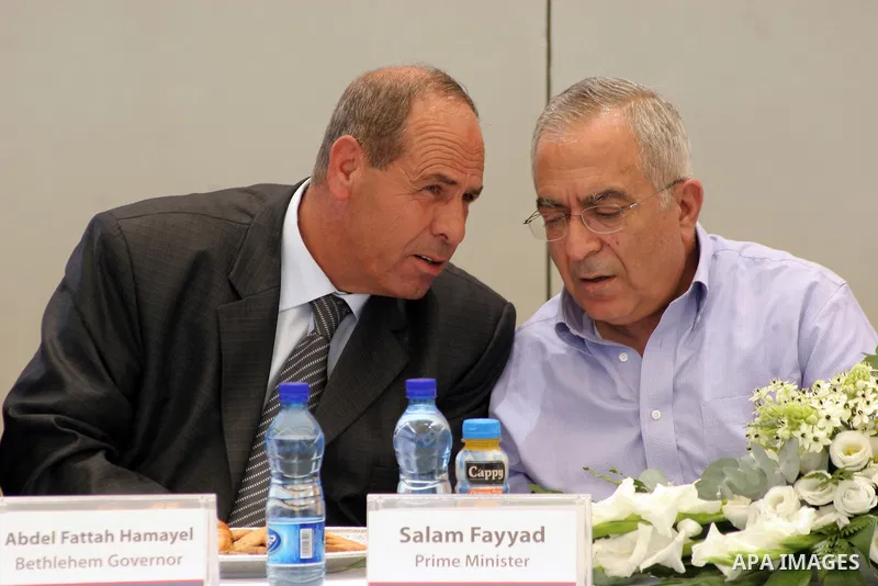 Palestinian prime minister Salam Fayyad talks with Abed Alfattah Hamayel (L) a Governor of Bethlehem during the inauguration ceremony for well stations rehabilitation project in the southern West Bank village of Tuqu'a,...