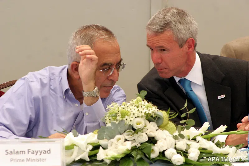 Palestinian prime minister Salam Fayyad talks with Michael T. Harvey a USAID Mission Director during the inauguration ceremony for well stations rehabilitation project in the southern West Bank village of Tuqu'a, which w...