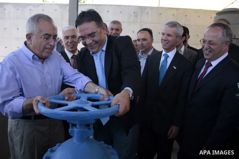 Palestinian Prime Minister Salam Fayyad and Michael T. Harvey a USAID Mission Derector talks during the attends the opening of wells and water pumps in Tquoa sothern the West Bank city of Bethlehem, June 22,2011. Photo b...