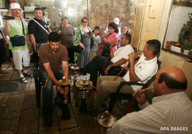 Palestinian men smoke waterpipes at a cafe in Jerusalem's old city on Jun 22,2011. Photo by Mahfouz Abu Turk