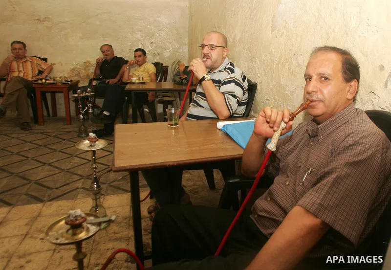 Palestinian men smoke waterpipes at a cafe in Jerusalem's old city on Jun 22,2011. Photo by Mahfouz Abu Turk