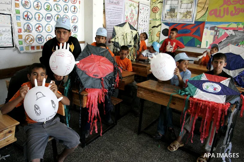 Palestinian boys play at a summer camp organised by UNRWA in Rafah, southern Gaza Strip on Jun 23, 2011. Photo by Abed Rahim Khatib