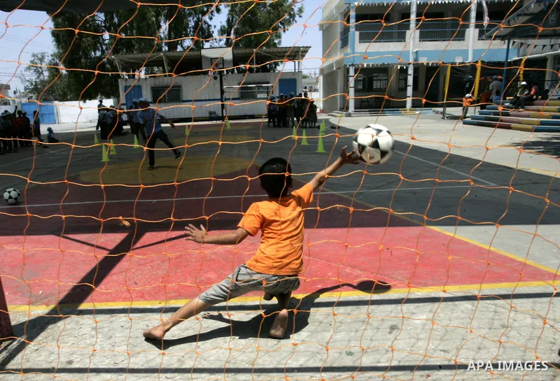 Palestinian boys play at a summer camp organised by UNRWA in Rafah, southern Gaza Strip on Jun 23, 2011. Photo by Abed Rahim Khatib