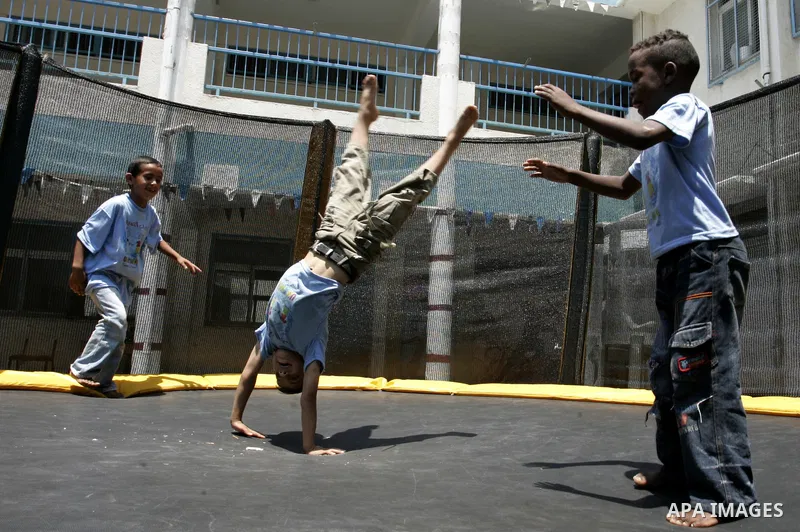 Palestinian boys play at a summer camp organised by UNRWA in Rafah, southern Gaza Strip on Jun 23, 2011. Photo by Abed Rahim Khatib