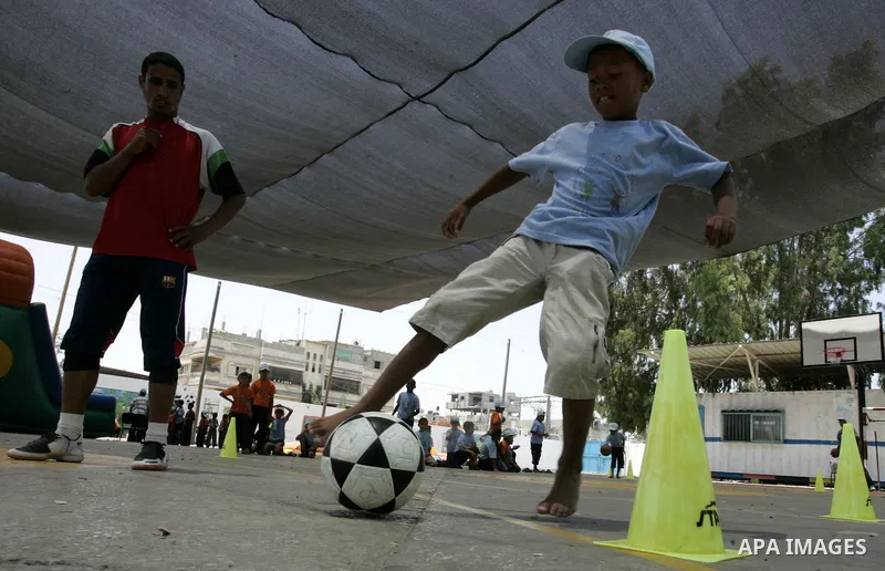 Palestinian boys play at a summer camp organised by UNRWA in Rafah, southern Gaza Strip on Jun 23, 2011. Photo by Abed Rahim Khatib