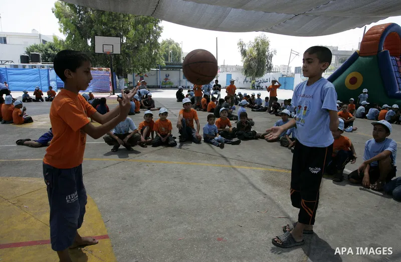Palestinian boys play at a summer camp organised by UNRWA in Rafah, southern Gaza Strip on Jun 23, 2011. Photo by Abed Rahim Khatib