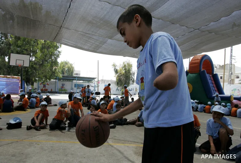 Palestinian boys play at a summer camp organised by UNRWA in Rafah, southern Gaza Strip on Jun 23, 2011. Photo by Abed Rahim Khatib
