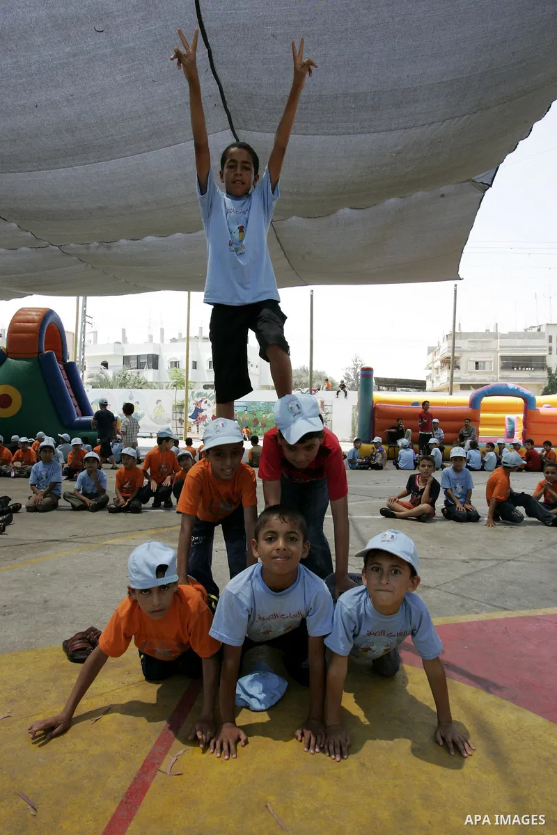 Palestinian boys play at a summer camp organised by UNRWA in Rafah, southern Gaza Strip on Jun 23, 2011. Photo by Abed Rahim Khatib