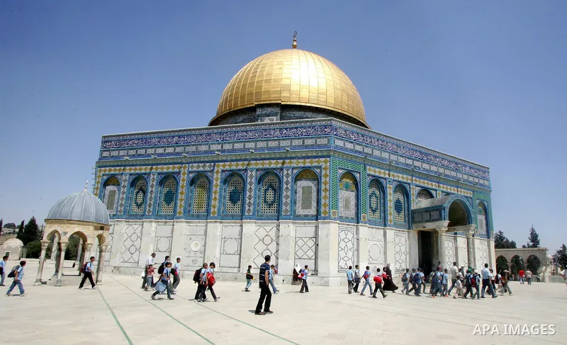 Palestinian schoolboys walk outside the Dome of the Rock at the Al-Aqsa Mosques compound in Jerusalem's Old City on Jun 23, 2011. Photo by Mahfouz Abu Turk