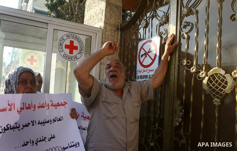 Palestinian prisoners relatives protest outside the International Committee of the Red Cross (ICRC) as dozens of angry protesters demonstrated outside the premises of the ICRC in Gaza City on June 23, 2011 against a call...
