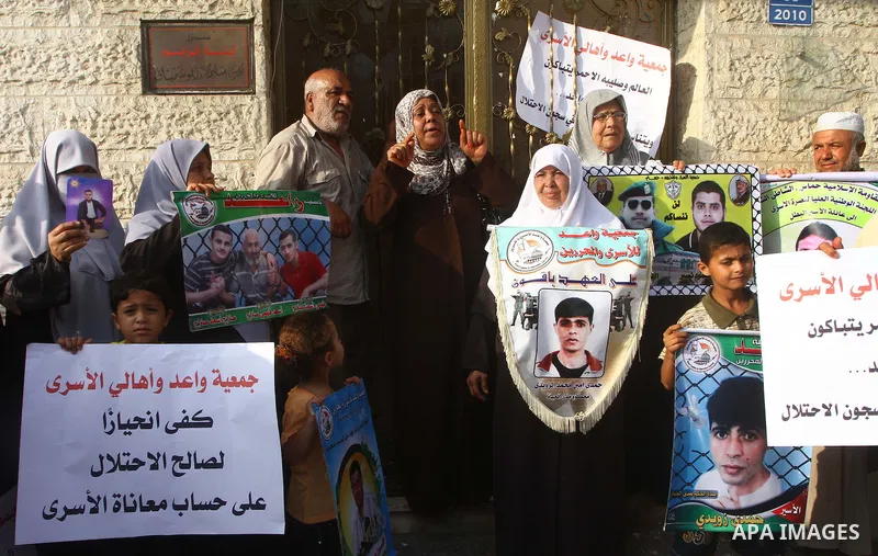 Palestinian prisoners relatives protest outside the International Committee of the Red Cross (ICRC) as dozens of angry protesters demonstrated outside the premises of the ICRC in Gaza City on June 23, 2011 against a call...