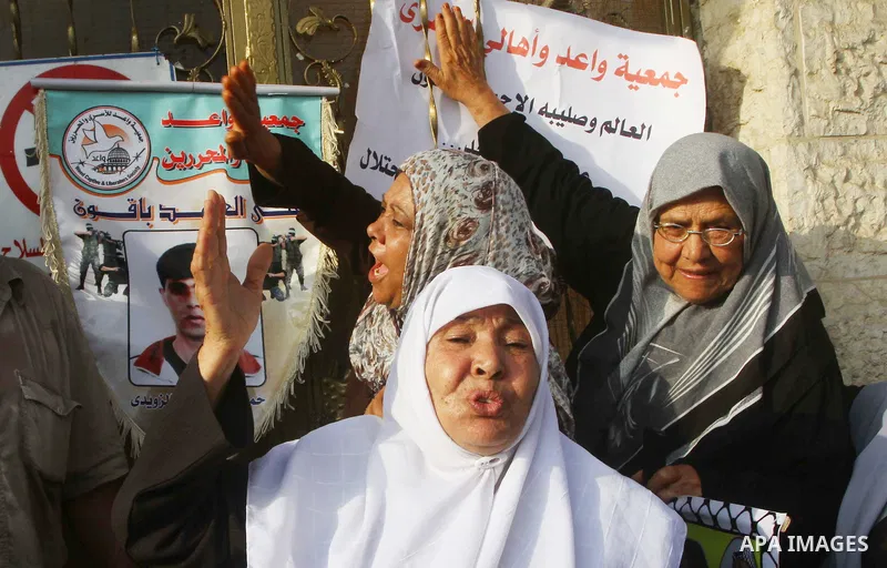 Palestinian prisoners relatives protest outside the International Committee of the Red Cross (ICRC) as dozens of angry protesters demonstrated outside the premises of the ICRC in Gaza City on June 23, 2011 against a call...