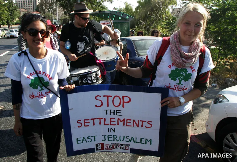 Israeli, Palestinian and foreign activists take part in a weekly demonstration against Israel's occupation of Palestinian land on Jun 24, 2011 in the mostly Arab Jerusalem neighborhood of Sheikh Jarrah. Photo by Mahfouz...