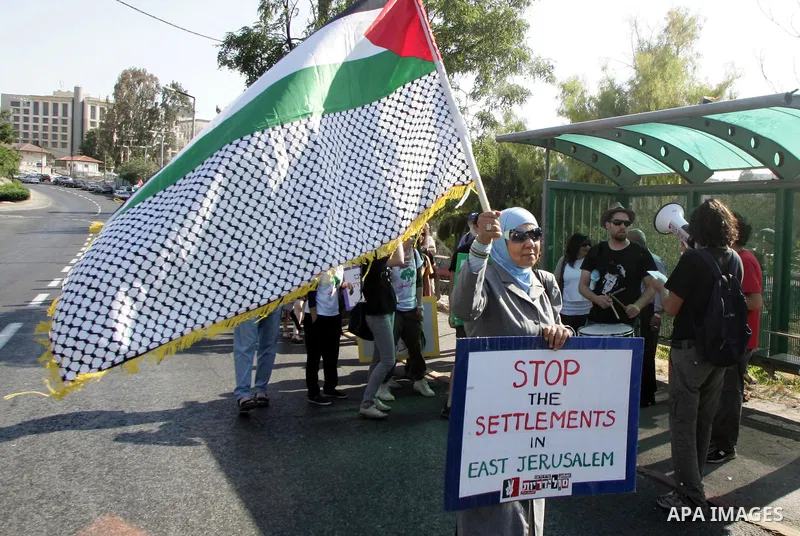 Israeli, Palestinian and foreign activists take part in a weekly demonstration against Israel's occupation of Palestinian land on Jun 24, 2011 in the mostly Arab Jerusalem neighborhood of Sheikh Jarrah. Photo by Mahfouz...